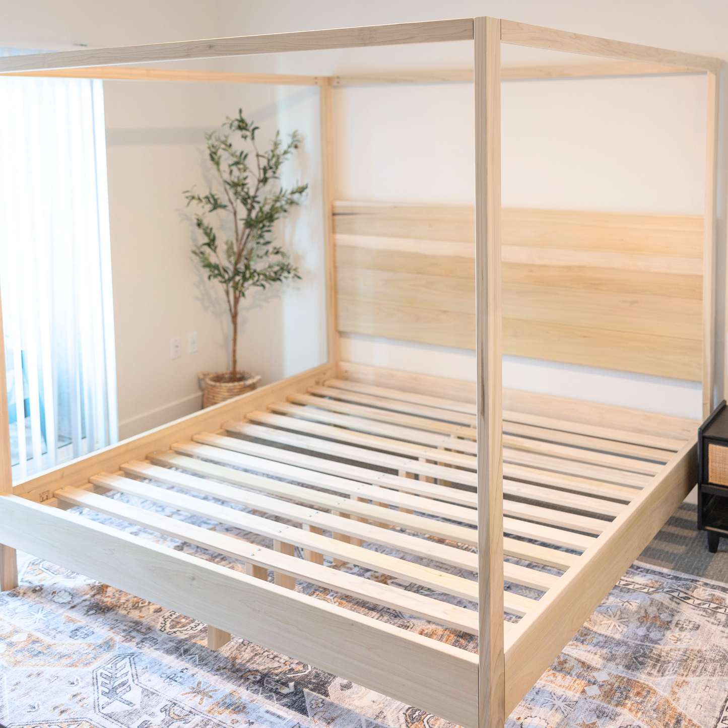 A solid poplar wood canopy bed, showcasing elegant craftsmanship and timeless design. The bed frame is constructed from sturdy poplar wood with a rich finish, featuring a classic canopy design that adds sophistication to any bedroom space.