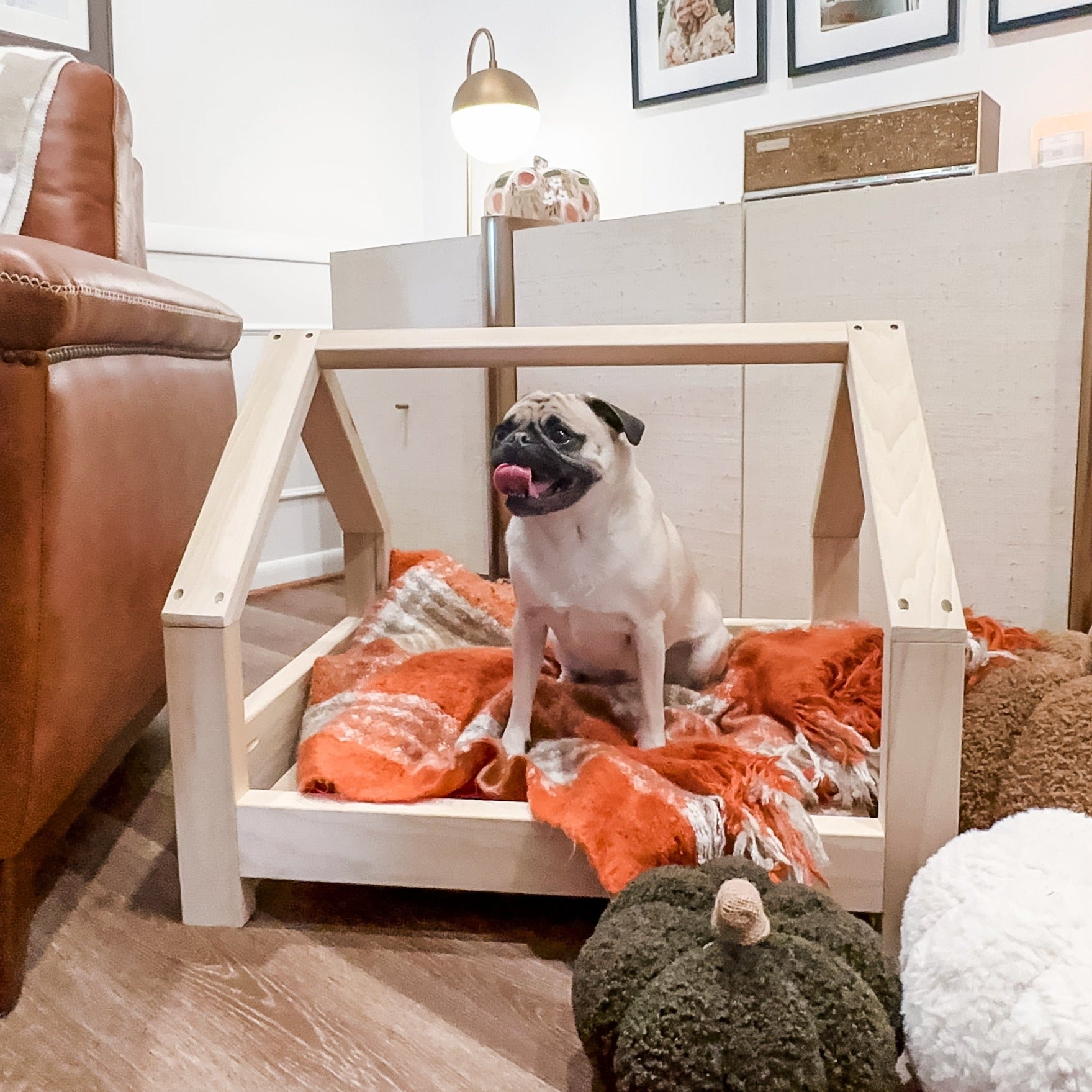 A miniature pet bed crafted entirely from smooth wood, designed for small animals such as cats or small dogs. The bed features a simple yet elegant frame, with rounded corners for comfort and safety. Inside, a soft cushion provides a cozy spot for pets to rest and relax. Placed in a cozy corner of the room with a small blanket nearby, this wooden pet bed offers a stylish and comfortable retreat for furry companions to curl up in.
