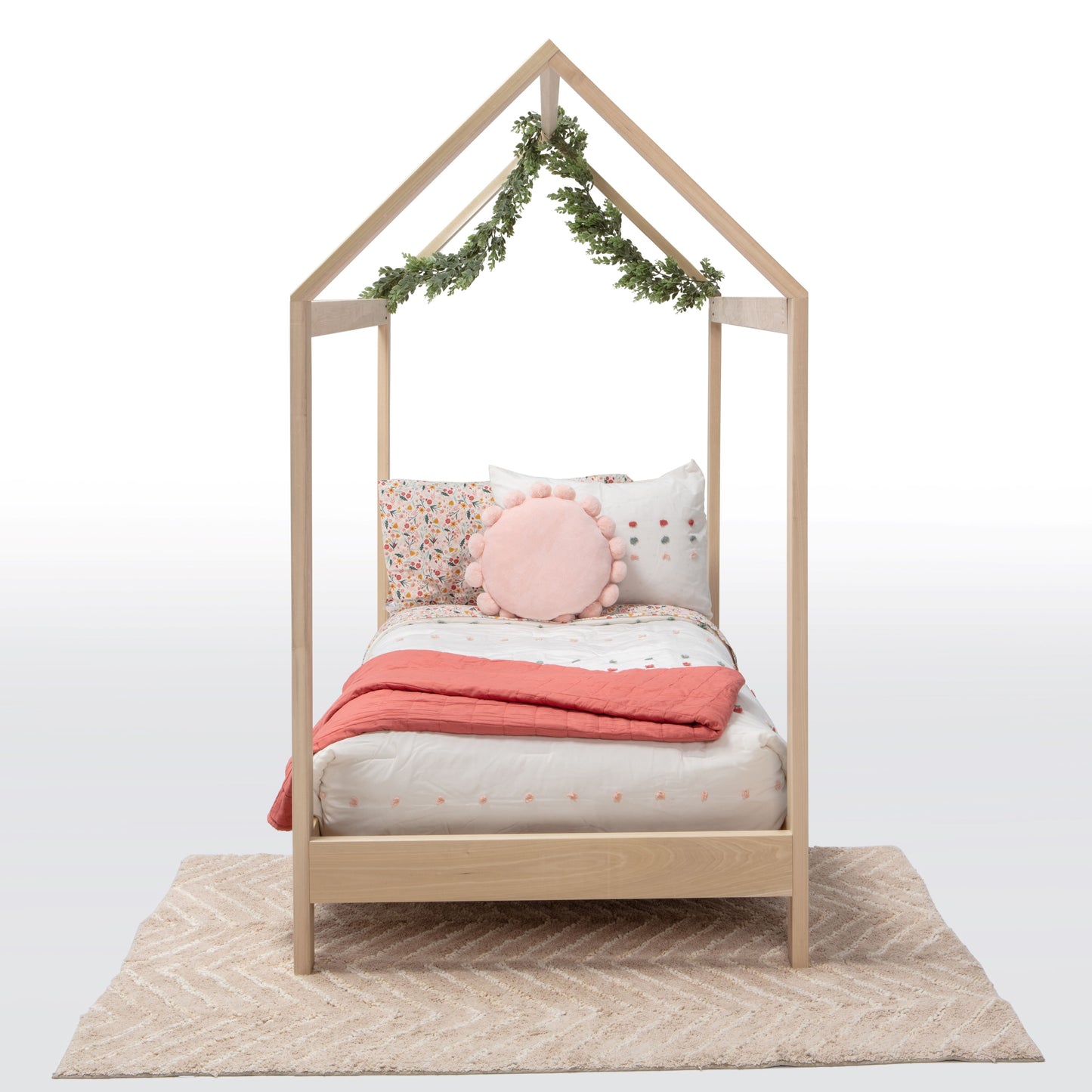 A charming house-shaped children's bed crafted entirely from natural wood, featuring a cozy and inviting design. The bed resembles a miniature house, complete with a peaked roof, window cutouts, and a sturdy wooden frame. Inside, a comfortable mattress is adorned with soft bedding, providing a cozy spot for children to sleep and play. With safety rails along the sides for added security, this wooden house bed creates a whimsical and imaginative sleep space for young ones to enjoy in their bedroom.