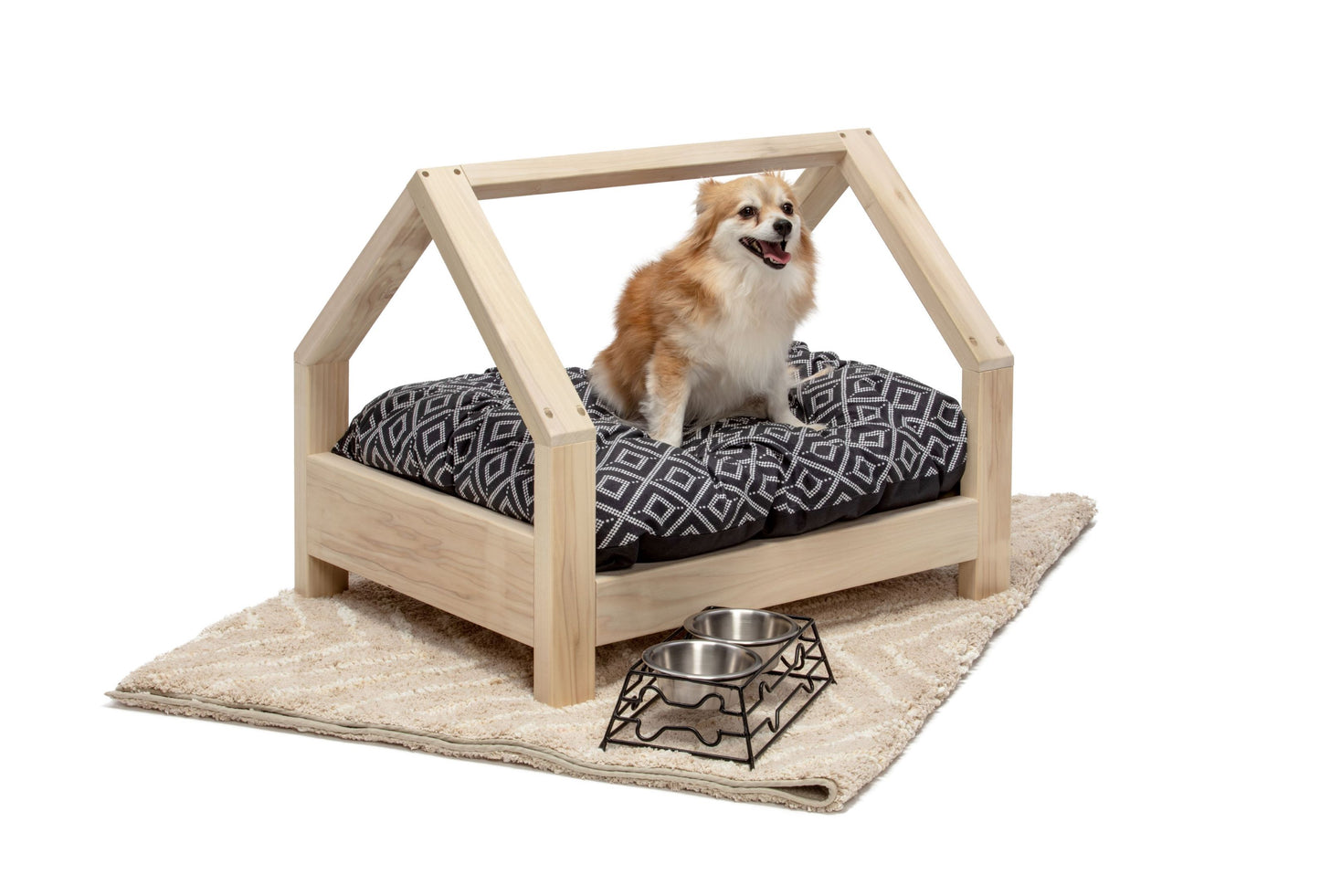 A miniature pet bed crafted entirely from smooth wood, designed for small animals such as cats or small dogs. The bed features a simple yet elegant frame, with rounded corners for comfort and safety. Inside, a soft cushion provides a cozy spot for pets to rest and relax. Placed in a cozy corner of the room with a small blanket nearby, this wooden pet bed offers a stylish and comfortable retreat for furry companions to curl up in.