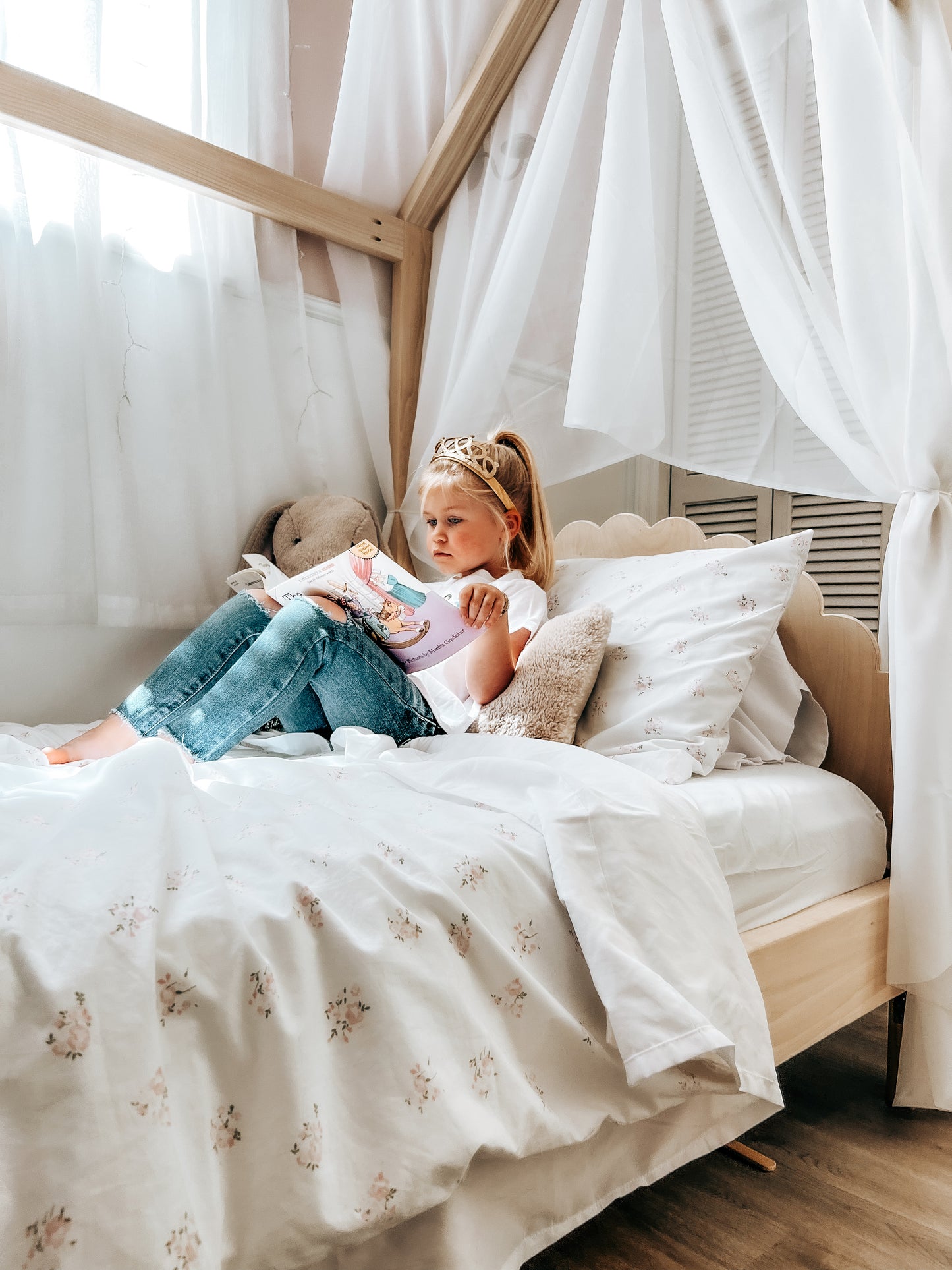 A cozy house-shaped children's bed made entirely of natural wood, featuring a headboard and footboard for added comfort and style. The bed resembles a quaint cottage. Crafted from sturdy wood, the frame provides stability and durability. Inside, a comfortable mattress with soft bedding invites children to rest and play. This wooden house bed with a headboard and footboard creates a cozy and inviting sleep space, perfect for fostering imagination and comfort in a child's bedroom.